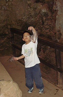 Ken in the cave with a bag of watermelon